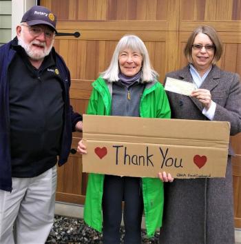 Belfast Rotary Club’s secretary Syrena Gatewood (r.) and president John Golden (l.) present a $2,000 check to the Greater Belfast Area Ministrium Food Cupboard, one of five recent gifts to food pantries. (Photo courtesy Phil Carthage, Belfast Rotary Club)