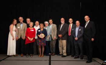 Deborah Meehan and Chamber Group - Deborah Meehan, the Penobscot Bay Regional Chamber of Commerce 2022 Community Person of the Year, is surrounded by Chamber leaders and previous Community Person of the Year honorees, including L to R: Sheila Lowe, Chamber Board Chair; Chris Rector, Bruce Gamage, Becky Gamage, Reade Brower, Deb Meehan, Ann Bresnahan, Rick Bresnahan, Gordon Page, Sandy Cox, Connie Russell, and Tom Peaco, Chamber President & CEO. (Photo courtesy Carol Miller Photography carolmillerphotos.com)