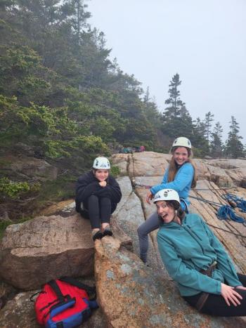 Members of Team Katmai, from Left to Right: Savannah Meyers student), Ashby Bartke (volunteer), and Meg Kivus (student) while rock-climbing at Acadia National Park, May 2022. Photo Credit: Mike McGuire.