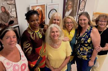 The Finding Our Voices exhibit at the University of Maine Hutchinson Center through October, with visiting survivors in the portraits left from right Mia from Lincolnville, Gloria, Liz, Janet, Patrisha, Betsy and Mary Lou. (Photo courtesy Finding Our Voices)