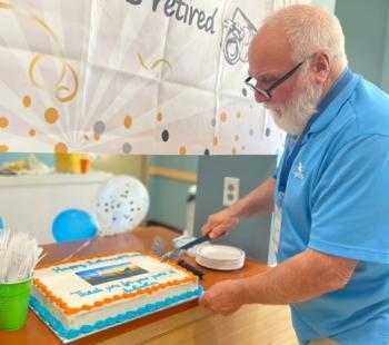 Rocky Stenger cuts his retirement cake. (Photo by Jeremy Shaw).