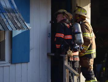 Rockport Fire Chief Jason Peasley and Camden Fire Chief Chris Farley assess the inside of the motel building. (Photo by Lynda Clancy)