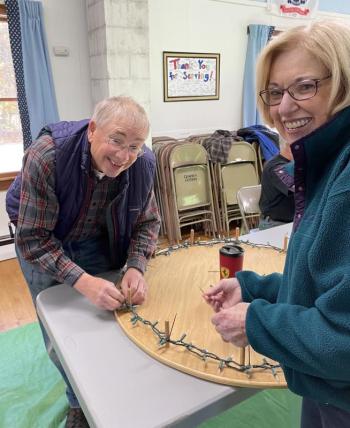 Camden Garden Club members use wooden frames to make the light loops for the 98 downtown lamppost wreaths. (Photo courtesy Camden Garden Club)