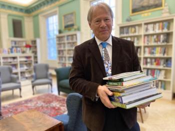 Belfast Free Library Director Steve Norman holding Belfast Garden Club book donations. (Photo courtesy Belfast Garden Club)