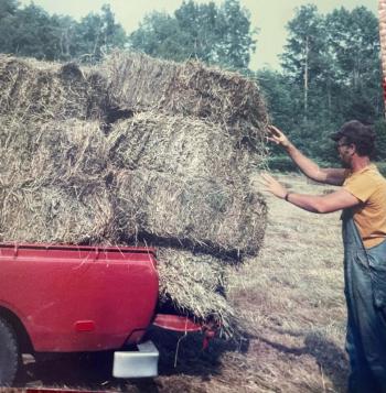 Wally O’Brien loads hay into the back of the old Toyota to feed the cow and pony for the coming winter. (Photo courtesy of Diane O’Brien) Hay