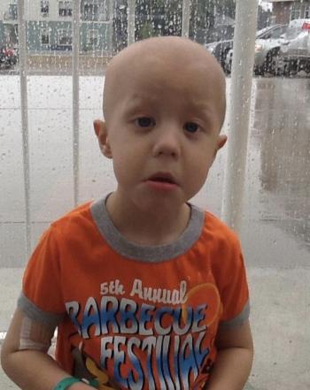 A boy stuck at the hospital and sad that his dad and siblings have to go home. (Photo by Ed O’Brien) Boy