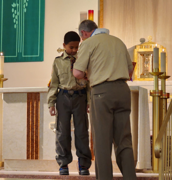 Skowhegan: Webelos Scout Joshua Gilpin from Pack 485 in Skowheganreceived his Parvuli Dei Catholic Religious Emblem at Scout Sunday on Sunday, February 5 at Notre Dame de Lourdes Church in the Parish of Christ the King in Skowhegan. Pinning the award is Dr. Scott Valcourt, chair of the Diocese of Portland’s Catholic Committee on Scouting. (Photo courtesy Chuck Mahaleris)