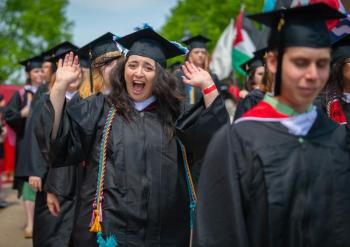 Members of Clark University's Class of 2023 walk to the campus green for the main Commencement ceremony. (Photo courtesy Clark University)