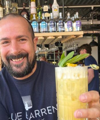 Andrew Stewart of Blue Barren in Camden with the "Into the Light!” Ease My Pain cocktail. Customers ordering this pineapple, coconut, mint, and rum drink in July are funding shelter, car, legal and food expenses for Maine’s domestic abuse survivors. (Photo by Patrisha McLean)