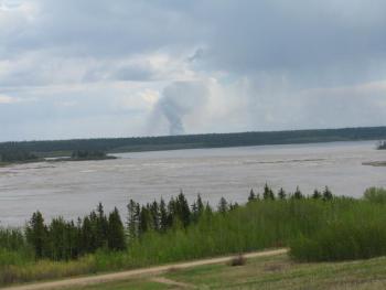 A column of smoke rises from a distant wildfire near Fort Smith, Northwest Territories. Courtesy of Jeff Wells. #bird-column, #jeff-and-allison-wells, #maine, #birds, #boothbay register, #boreal forest, #canadian wildfires