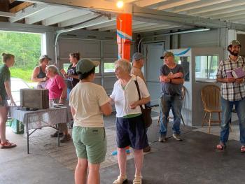 MFA’s Carly Williams (left) and MCHT’s Aaron Englander (right) connect with farmers and community members. Photos courtesy of Maine Farmland Trust