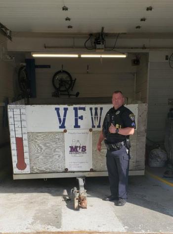 Belfast Police Sergeant Rick Smith stands with the recovered trailer. (photo courtesy of Belfast Police)
