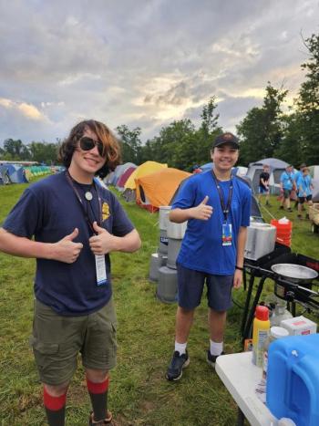 Anthony Fortin of Troop 603 and Connor Poirier of Troop 631, both of Augusta, gave the thumbs up as they began cooking breakfast for the contingent at the sub-camp campsite at the Summit Reserve. (Photo courtesy Chuck Mahaleris)