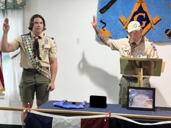 Scoutmaster Ed Weber, an Eagle Scout, administers the Eagle Scout Charge to Matthew Clayton. (Photo courtesy Chuck Mahaleris)