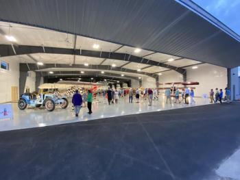 Guests of the Owls Head Transportation Museum gather inside the new workshop hangar. (Photo by by Louis Bettcher)