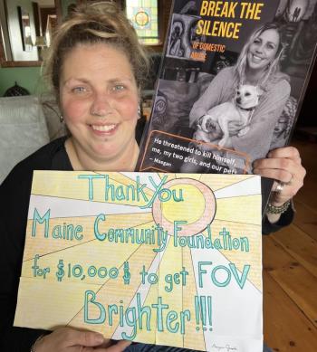 Maegan Graslie is an artist and UMA student in Ellsworth. She is also one of 45 Maine survivors on the Finding Our Voices domestic abuse-awareness posters and bookmarks that have been posted and distributed all across Maine, Here she is with her poster and a Thank You card she created for the Maine Community Foundation. (Photo by Patrisha McLean)