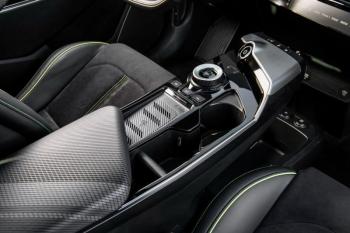 As an EV, the GT has no transmission; the two motors power their respective axles directly. On the angled panel is the start/stop button. The large dial is the drive – neutral - reverse selector; the button in the center selects Park and activates the electronic e-brake. Paddles behind the steering wheel let the driver choose the degree of regenerative braking, for one-pedal driving.