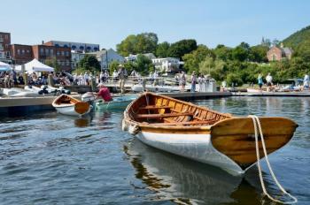 Richard Stetson gets the elegant wooden skiffs over to the dock. (Photo by Lynda Clancy)