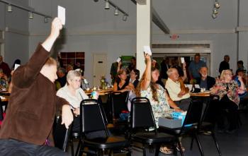 The bidding was fast and furious at “Evening by the Bay,” the charitable auction held at United Farmers Market to launch Belfast Rotary Club’s Harbor Fest on August 18. (Photo courtesy Phil Carthage, Belfast Rotary Club)