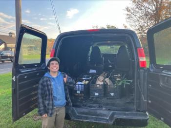 Matsu Hikida, Erickson Fields Program Assistant, loads the van with 12 heavy crates of produce for deliveries to four food pantries. (Photo courtesy MCHT)
