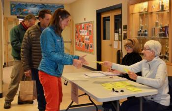 Lincolnville voters sign in at the door Dec. 11. (Photo by Lynda Clancy)