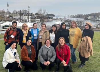 Iraqi domestic violence activists visited with Finding Our Voices in Camden on a State Department-sponsored tour of the United States. Finding Our Voices Founder/CEO Patrisha McLean is second from the left in the back. Finding Our Voices Operations Manager Mary Kamradt is in this same row second from the right. Allison Hodgkins, executive director of the World Affairs Council of Maine, is in the front with the grey sweater. (Photo by Matt LaJoie of the Camden Public Library)