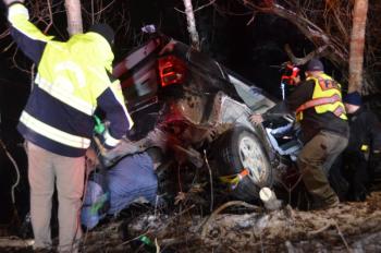 Rockport firefighters work quickly to stabilize the Jeep so that they can rescue the driver, as her vehicle hangs but five feet above the icy quarry. (Photo by Lynda Clancy)