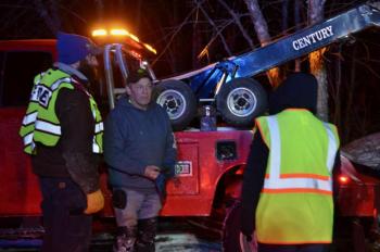 Rockport Lt. Chief Clay Tolman and Camden Exxon owner Steve Laite, after the Jeep is hauled up from the quarry’s edge. (Photo by Lynda Clancy)