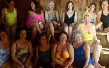 Wander Woman Tours alumni and friends in Erja Lipponen’s Finish Sauna. Wine and hot soup was served afterwards in a lakeside cottage. (Photo by Erja Lipponen)