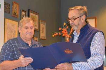 Retiring Knox County Regional Airport director Jeffrey Northgraves (left), looks on as State Legislator Representative Dave Miramant reads aloud from Northgraves’ certificate of recognition in 2019 when Knox County legislators surprise airport Manager Jeff Northgraves with state recognition. (Photo by Sarah Thompson)