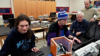 Andy Sheaff (far right) and Rick Eason (center right) working with two students on a camera system to attach to a large balloon that they will launch on April 8 to livestream the total solar eclipse.