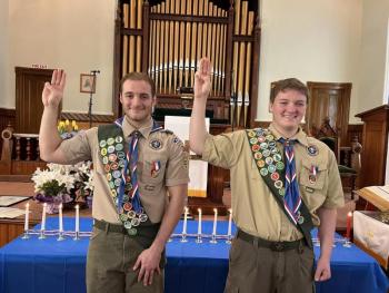 Eagle Scouts Bruce Bossow, Jr. and Eric Richmond make the Scout Sign during their Eagle Scout ceremony. (Photo courtesy Chuck Mahaleris)