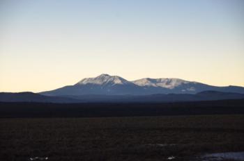 Katahdin’s snowy flanks lightened as the moon moved away from the sun, allowing its rightful place in the day. (Photo by Lynda Clancy)