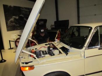 Getting into the guts of a classic, gasoline-powered vehicle that was converted to run on electricity. Made by Damariscotta, Maine company, Nomad Motors. Photo by Kay Stephens