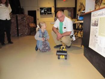 Saturday was the public day for families of all ages to explore the museum’s hands-on activities and meet with professionals in STEM. Operating a robotic lego-built tractor. Photo by Kay Stephens