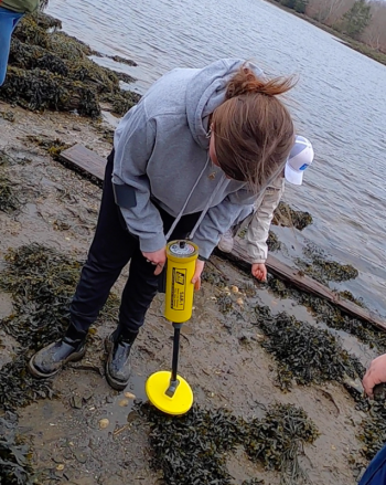 Using their underwater metal detector BMI students count and record the magnetic hits of iron ship spikes found on the wreck. (Photo by Charles H. Lagerbom, BMI)