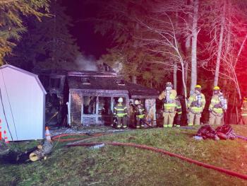 Firefighters look for any remaining flames after battling a house fire at 59 Levenseller Pond Road, in Searsmont. (Photo by Bradlee Watts)