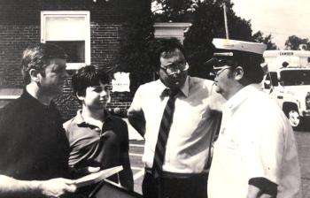 Fire Chief Robert Oxton talks with Maine Gov. Joe Brennan (far left), with one of Camden’s ambulances in the background. (Photo courtesy Walsh History Center/Camden Public Library) Camden ambulance