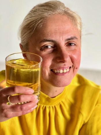 Clementina Senatore, of Paper Plane, with her Camden cocktail lounge’s July “Into the Light” drink featuring bergamot liquor and Oolong tea. Senatore, who came to Maine from Italy nine years ago “by myself, with no family or friends here,” said she stepped up to the Finding Our Voices fundraiser for domestic abuse victims because “I support courage.” (Photo by Patrisha McLean)