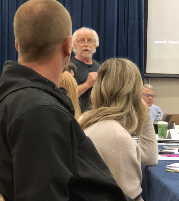 RSU40 Board Members Joseph Henry and Nichole Taylor listen to Randy Kassa (center) state his reasons for voting to delete a policy which sets out guidelines for district staff to follow state and federal law pertaining to the rights of transgender and gender nonconforming students. (Sarah Masters photo)