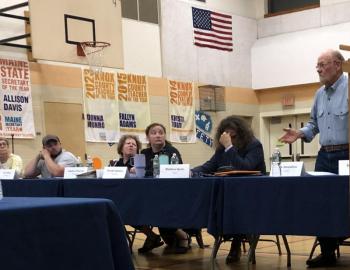 From left: School Board Members Naomi Aho, Noah Botley, Brooke Simmons, and Matthew Speno, listen to Erik Amundsen argue in favor of keeping a policy which directs district staff on how to best follow the law and protect the rights of transgender and gender expansive students in Union on May 18. (Sarah Masters photo)