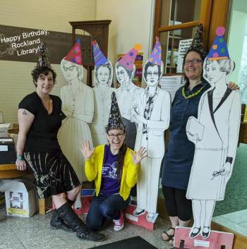 Jessie, Patty, and children’s librarian Katie Drago with cutouts of some of the former head librarians on the 115th birthday of the library in 2019. (Photo courtesy Rockland Public Library)