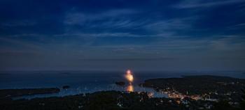 A panoramic shot of Camden Harbor, and in the distance: Owl’s Head Light, Heron Neck Light (dead center, in extreme background, on Green’s Island, off Vinalhaven) and the three turbines on Vinalhaven. (Photo courtesy Peter Ralston)