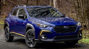 With both rear seatbacks folded down, the re-designed 2024 Crosstrek offers up to 54.7 cubic feet of useful space plus a tailgate opening that’s 41 inches across. The Sport model gets raised roof rails. (Think kayaks, paddleboards, skis.) This color is Sapphire Blue Pearl; note the hot-gold highlights and the Sport trim’s 18-inch Dark Gray Alloy wheels.