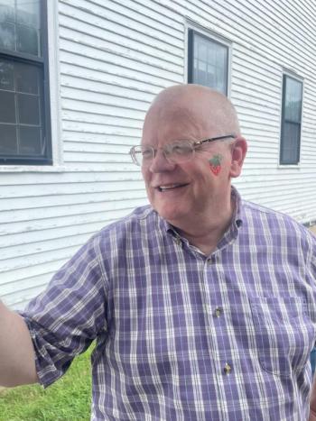 David Kinney poses with his strawberry painted face. (Photo by Ed O’Brien)