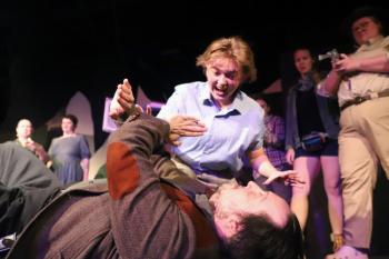Bat Boy (Miles Mailloux) attacks Dr. Parker (Andrew Lipman) as the
citizens of Hope Falls look on. (l-r in background: Christine Goosman, Angelina Nichols, Ada Curry, Gwen Sauvage). (Photo courtesy Belfast Maskers)