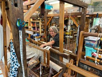 Diane O’Brien at work on her old barn loom. (Photo by Ed O’Brien)