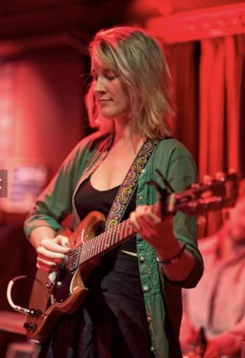 Local singer/songwriter/guitar player Louisa Stancioff rocks out during a concert. Catch her live on Aug, 15 or Sep. 6 in Camden. (Photo by Hear and There Photo)