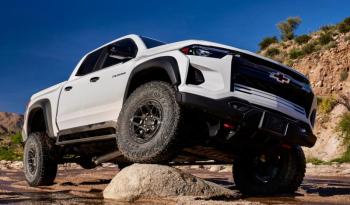 The Silverado ZR2 Crew in its natural habitat. Summit White (with a Jet Black and Graystone interior) makes the pair of bow-mounted red tow hooks pop.