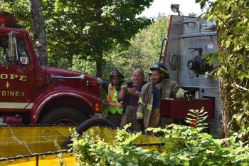 Long after the fire was knocked down, Hope and Lincolnville firefighters wait for the Fire Marshal’s Office. (Photo by Sarah Thompson)
